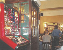 scene of a pub with a fruit machine